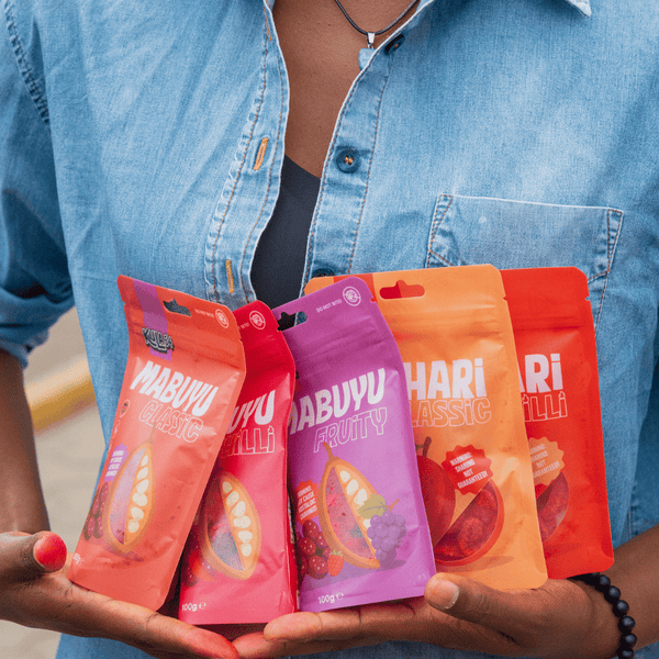 Person holding pouches of Mabuyu Classic, Chilli & Fruity and Achari Classic & Chilli