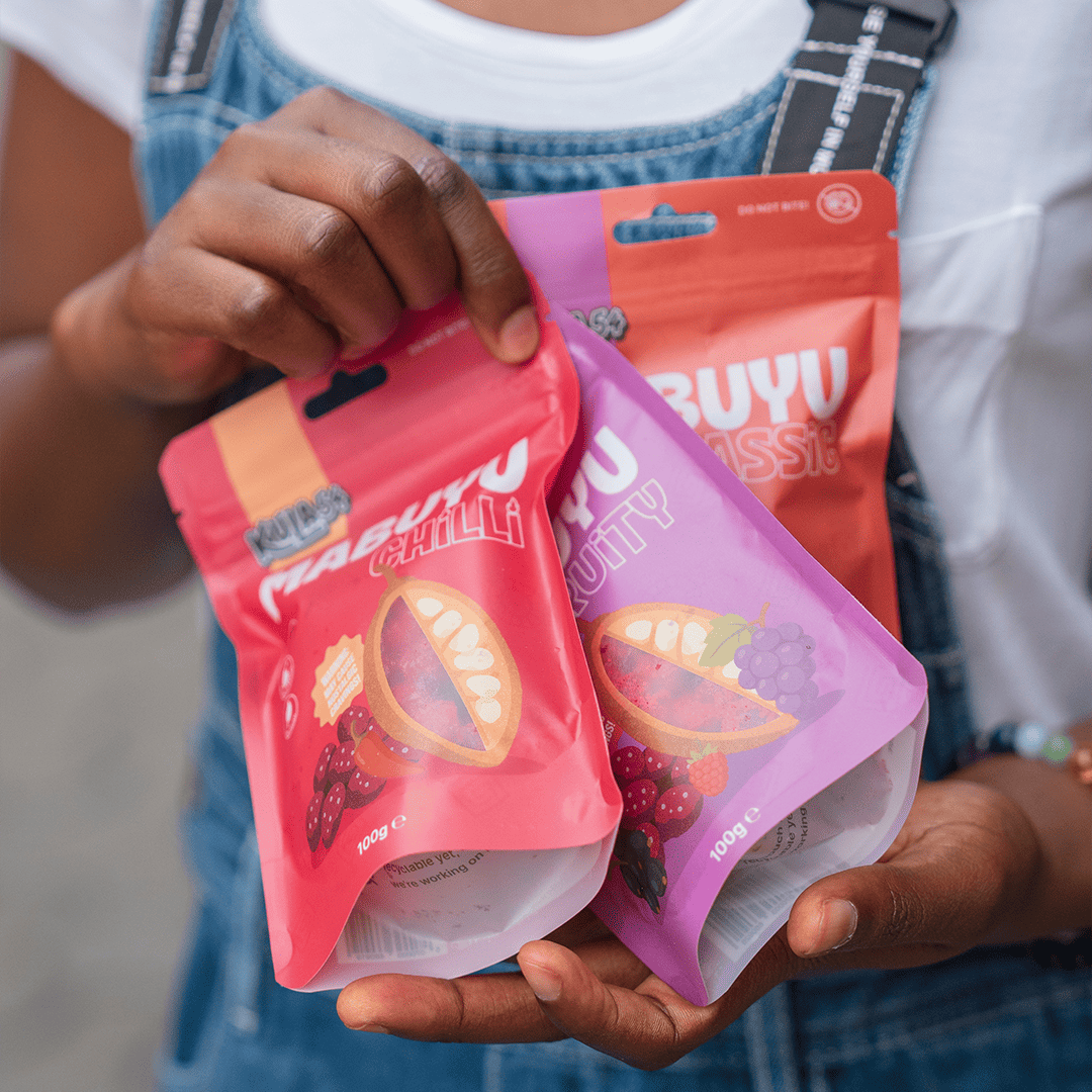 Person holding pouch of Mabuyu Classic, Chilli & Fruity