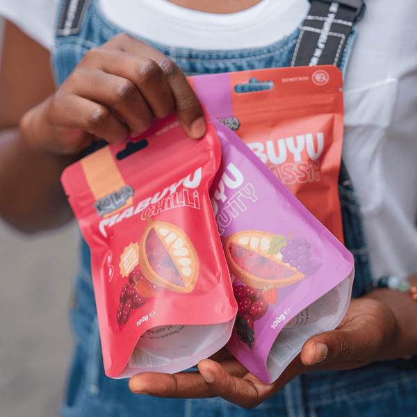 Person holding pouch of Mabuyu Classic, Chilli & Fruity